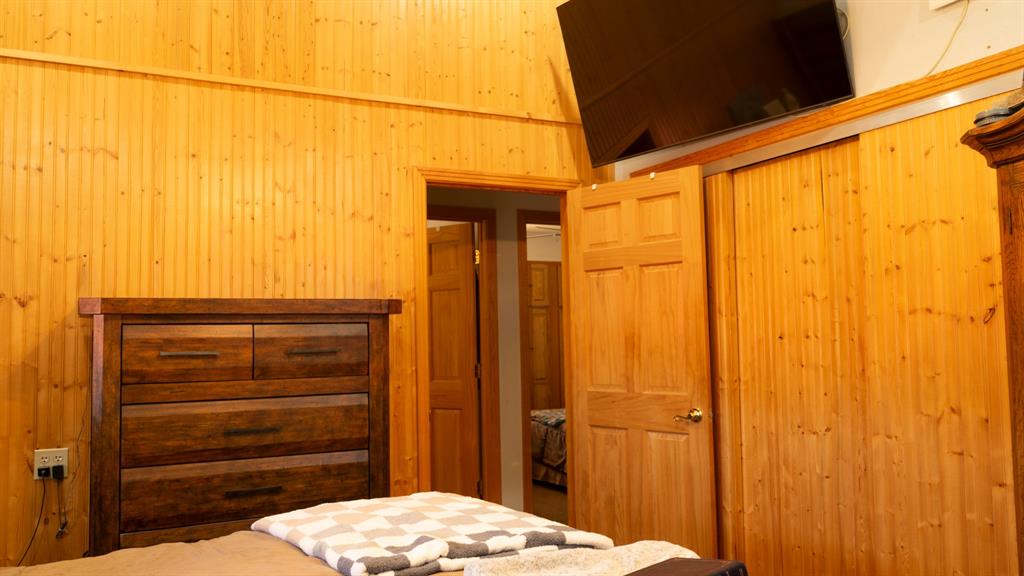 140 Baize Road Abilene, TX 79602 - Photo 18 of 37 Bedroom with a closet and wooden walls
