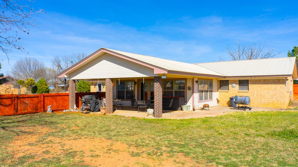 140 Baize Road Abilene, TX 79602 - Photo 2 of 37 Back of house featuring a fenced backyard, a patio, and brick siding