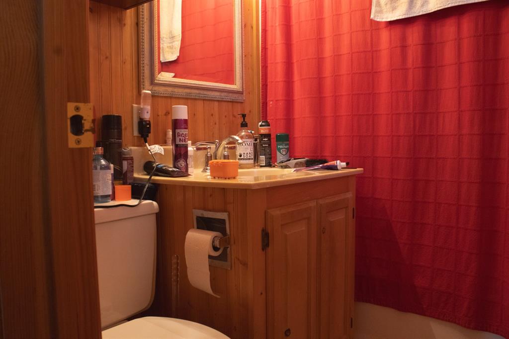 140 Baize Road Abilene, TX 79602 - Photo 23 of 37 Half bath featuring vanity and wooden walls
