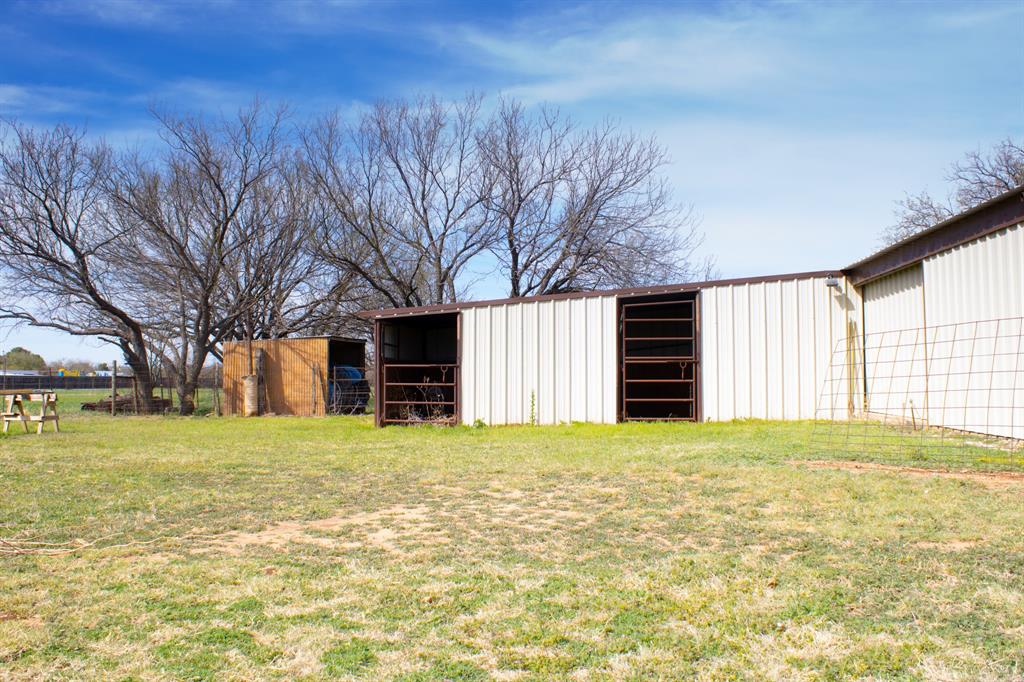 140 Baize Road Abilene, TX 79602 - Photo 34 of 37 View of grassy yard with an outdoor structure and an outbuilding