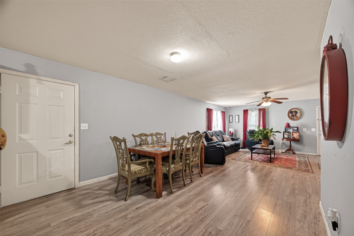 7100 Harlem Street Baytown, TX 77521 - Photo 11 of 30 a view of a dining room with furniture and wooden floor