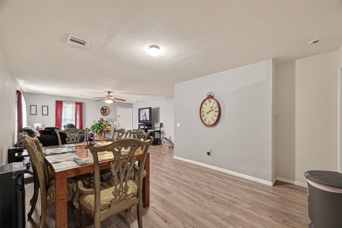 7100 Harlem Street Baytown, TX 77521 - Photo 12 of 30 a view of a dining room with furniture and wooden floor