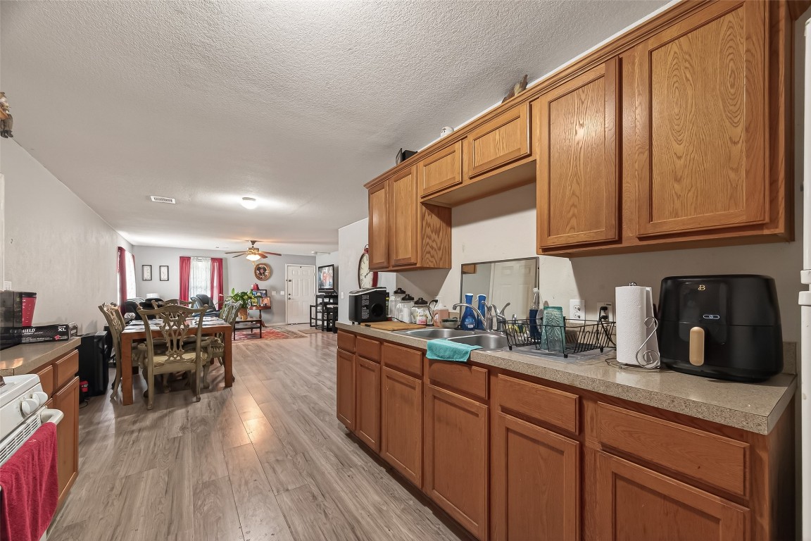 7100 Harlem Street Baytown, TX 77521 - Photo 16 of 30 a kitchen with lots of counter top space and dining table