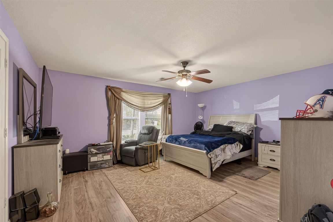 7100 Harlem Street Baytown, TX 77521 - Photo 22 of 30 a living room with furniture and a flat screen tv