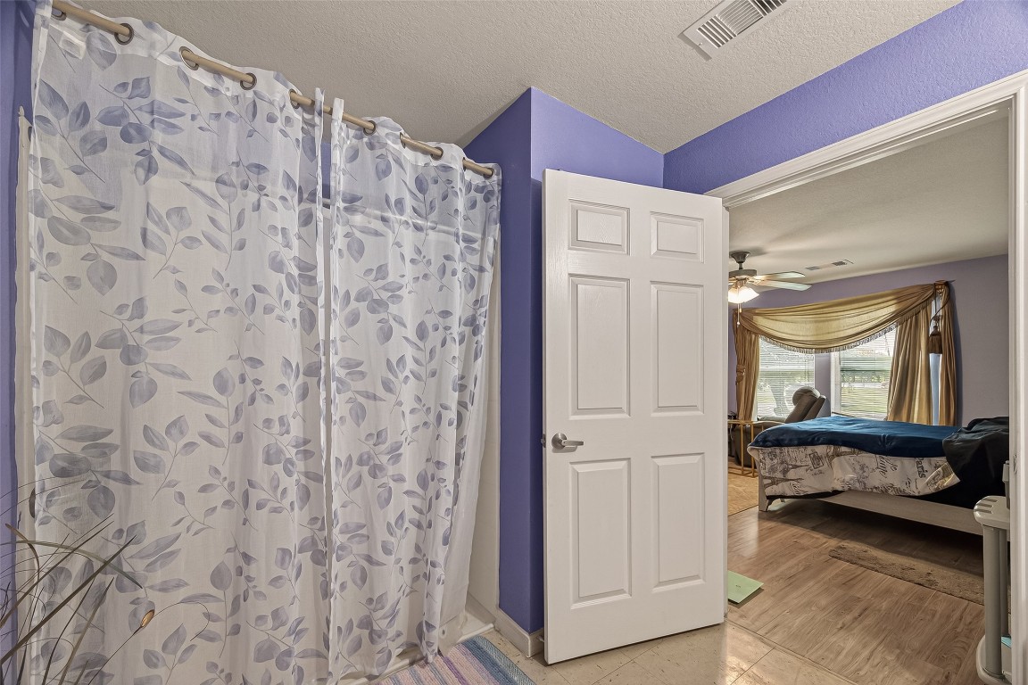 7100 Harlem Street Baytown, TX 77521 - Photo 26 of 30 a en suite bathroom with a shower and a mirror