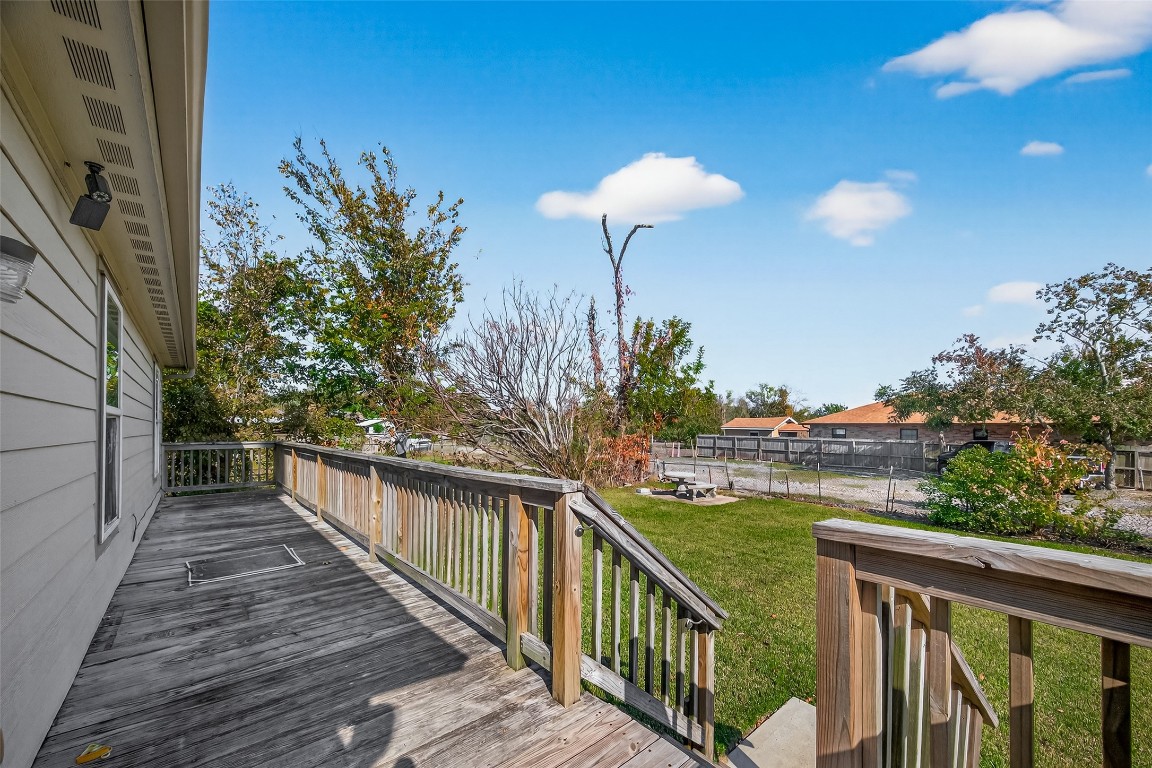 7100 Harlem Street Baytown, TX 77521 - Photo 27 of 30 a view of a balcony with wooden floor