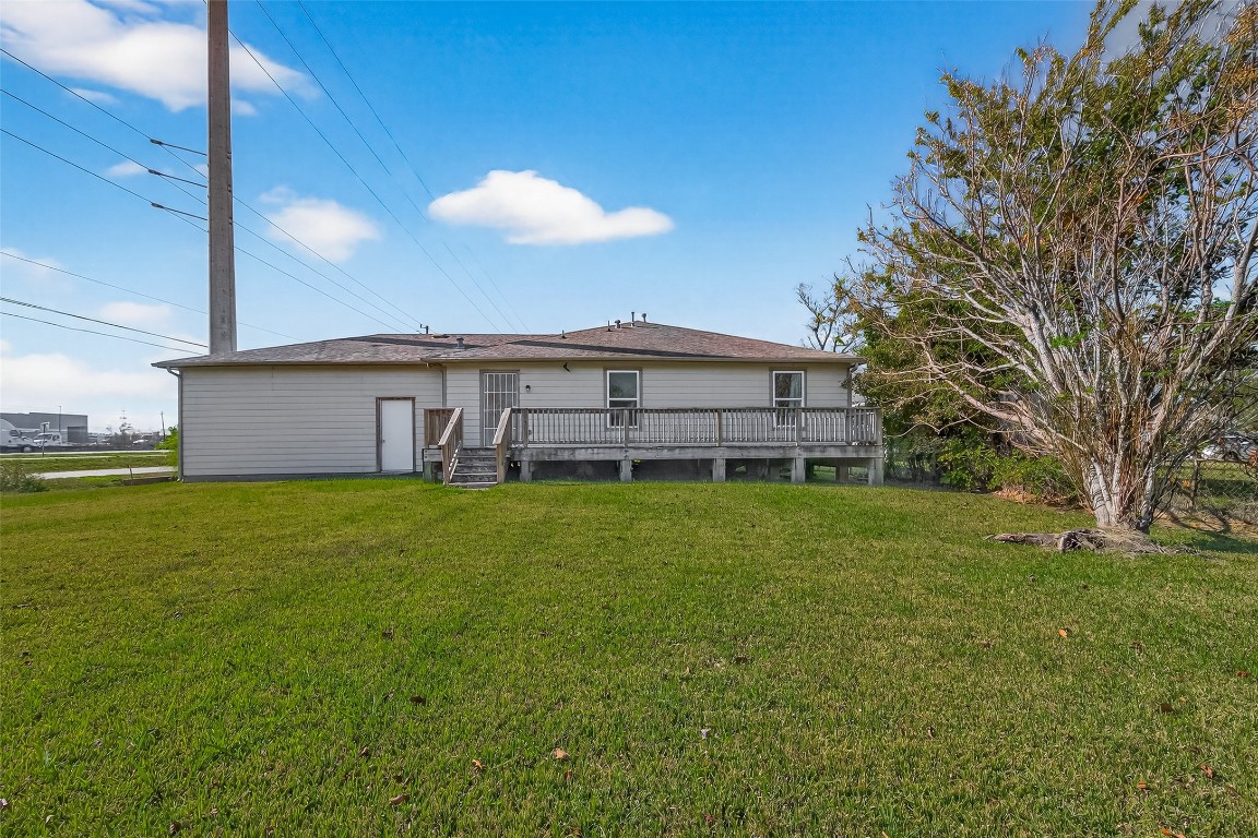 7100 Harlem Street Baytown, TX 77521 - Photo 29 of 30 a view of a house with a backyard