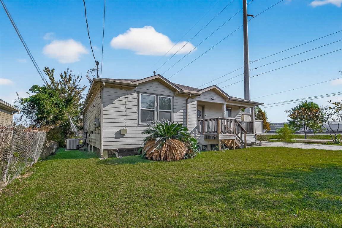 7100 Harlem Street Baytown, TX 77521 - Photo 3 of 30 a view of a house with a big yard and potted plants