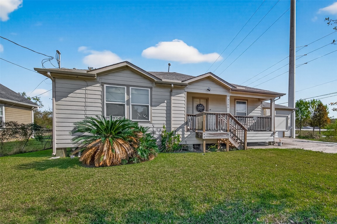 7100 Harlem Street Baytown, TX 77521 - Photo 4 of 30 a front view of a house with a yard and porch