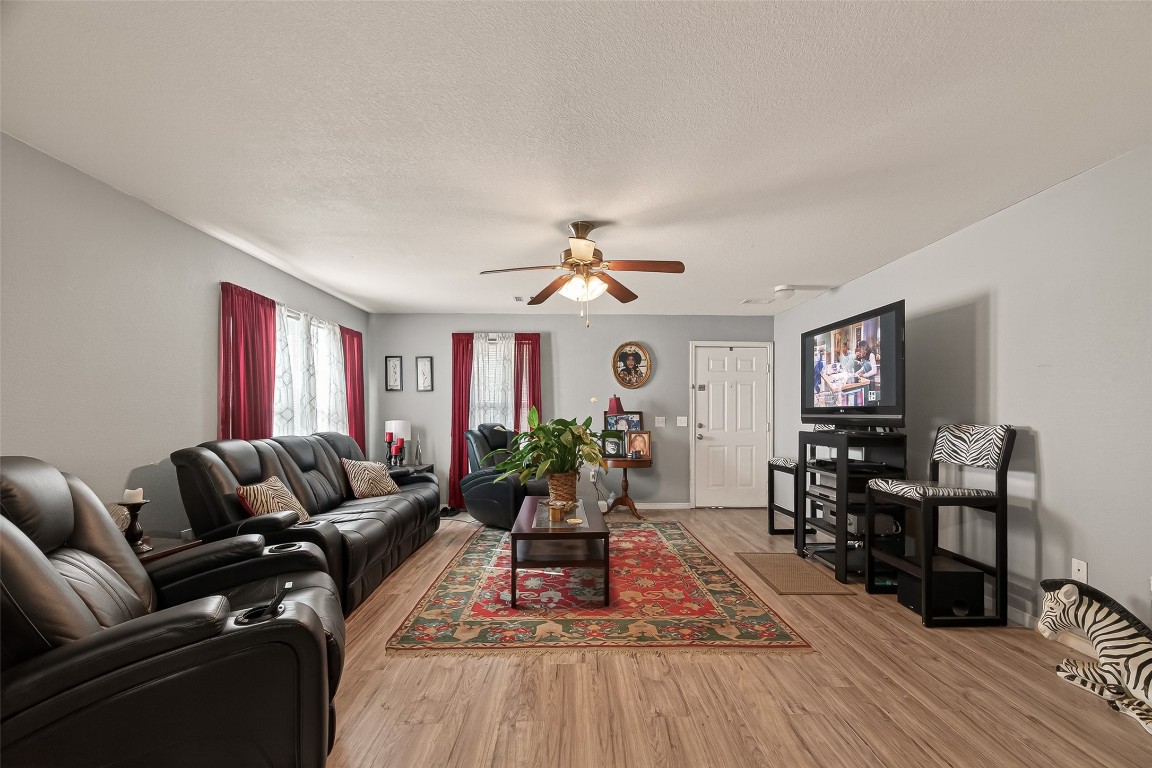 7100 Harlem Street Baytown, TX 77521 - Photo 9 of 30 a living room with furniture fireplace and wooden floor
