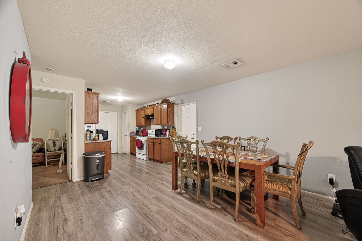7100 Harlem Street Baytown, TX 77521 - Photo 10 of 30 a view of a dining room with furniture and wooden floor