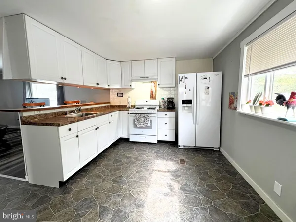 a kitchen with a white cabinets and white appliances