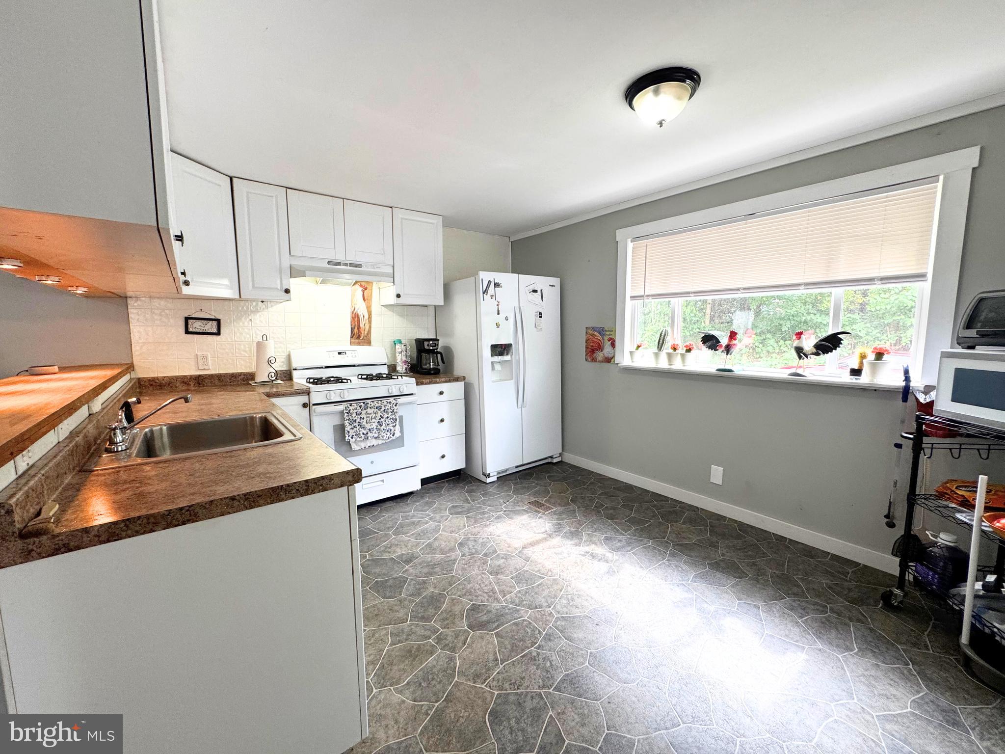 18 Alexander Avenue Jackson, NJ 08527 - Photo 14 of 22 a kitchen that has a lot of cabinets a sink and a stove