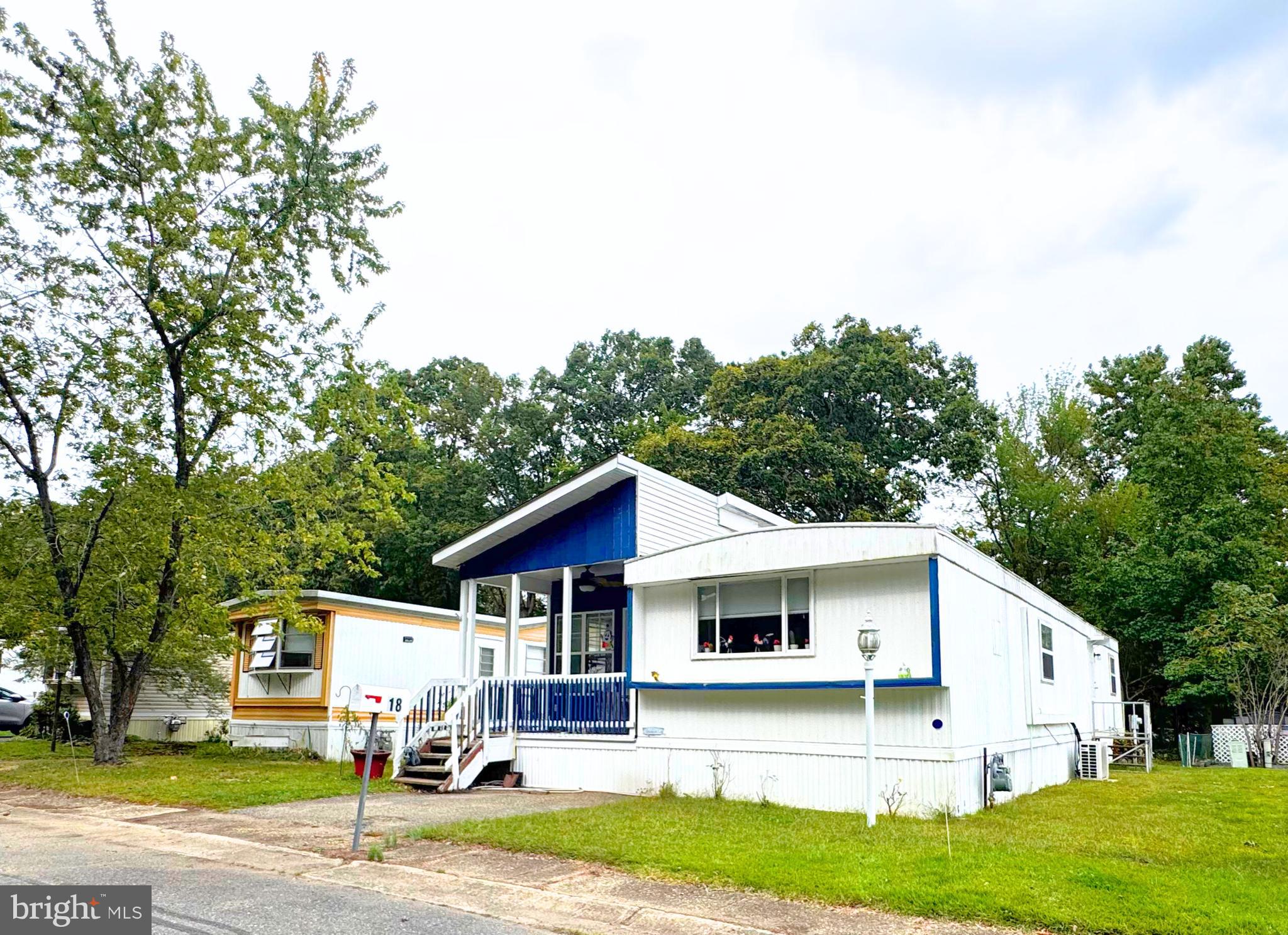 18 Alexander Avenue Jackson, NJ 08527 - Photo 4 of 22 a view of a white house with a big yard plants and large trees