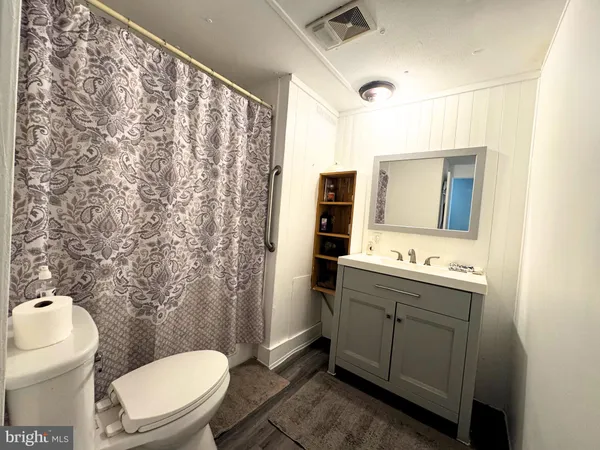 a bathroom with a toilet sink and mirror
