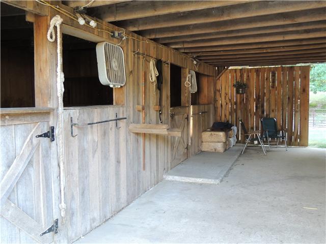 261 Hopkins Road Pulaski, TN 38478 - Photo 7 of 14 2 larger interior hunter stalls and 3-10x10 stalls with rubber mats. Hot water wash rack and brushed concrete floor.