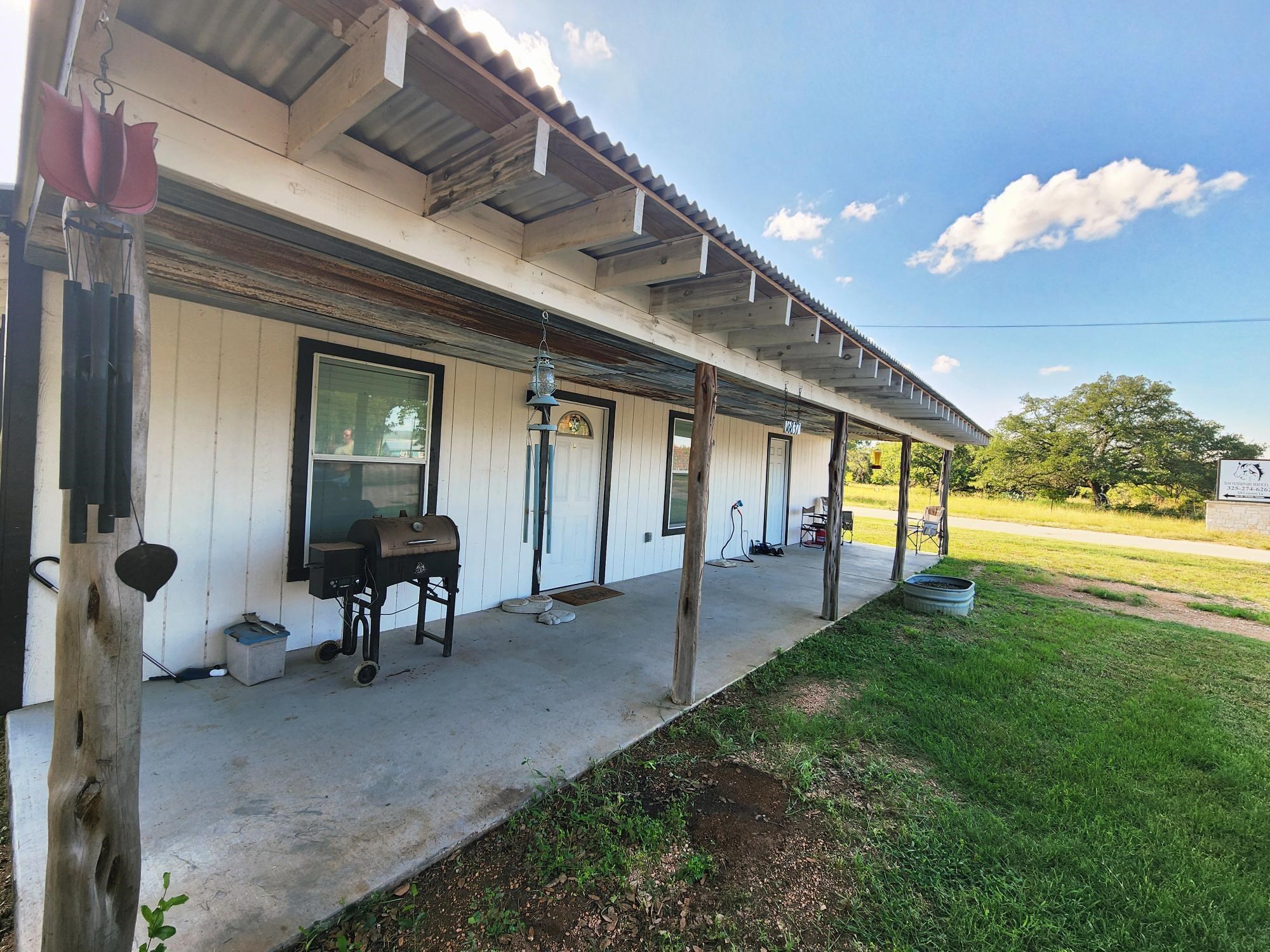 a view of a house with backyard porch and sitting area
