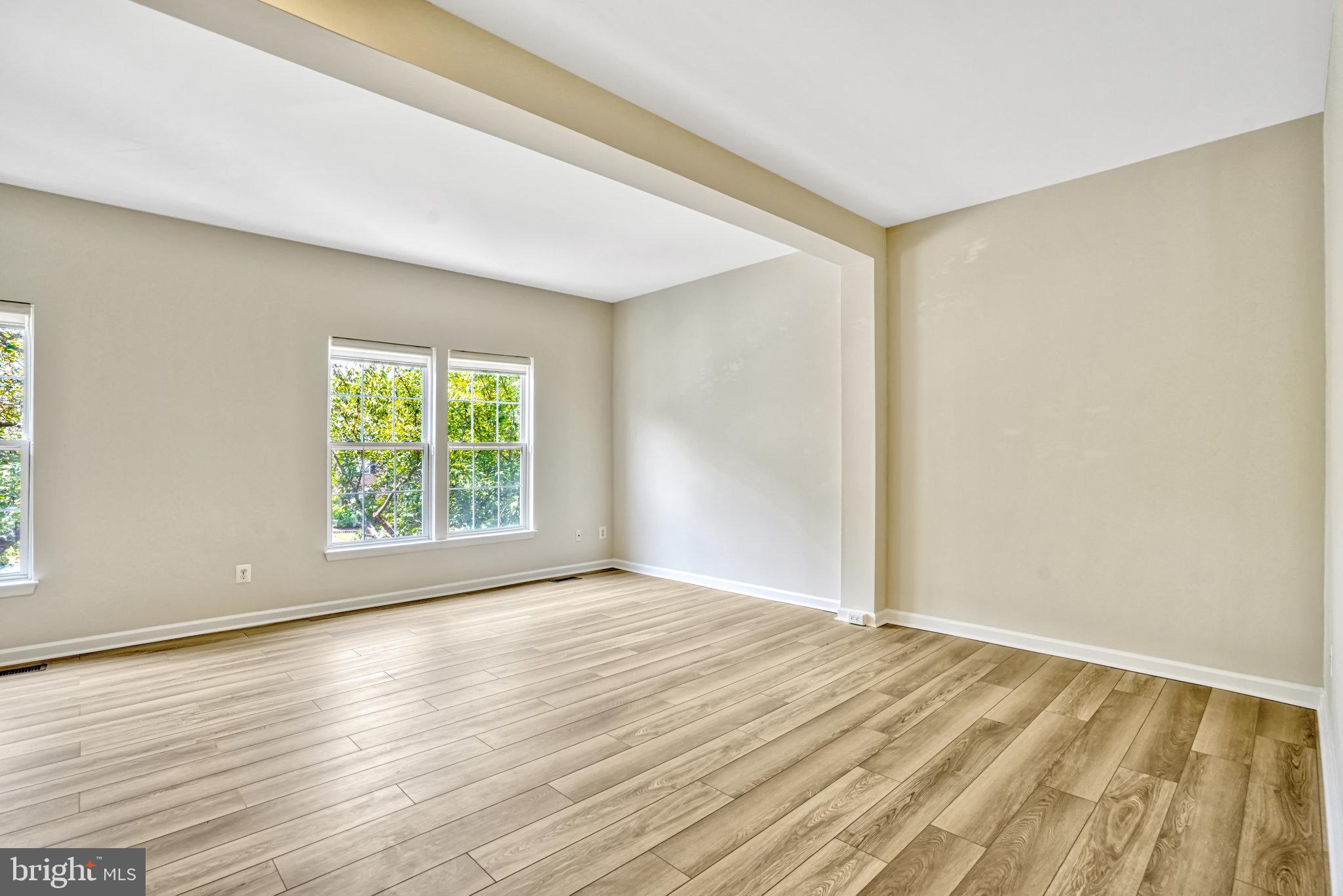 10159 Elgin Way Bristow, VA 20136 - Photo 19 of 50 an empty room with wooden floor and windows