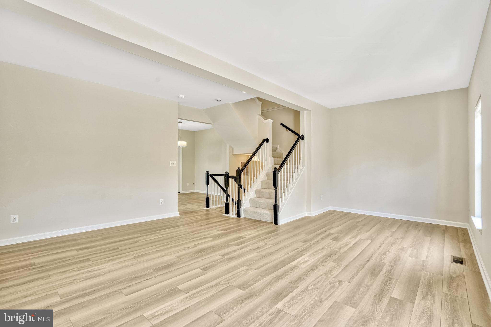 10159 Elgin Way Bristow, VA 20136 - Photo 21 of 50 a view of an empty room with wooden floor and stairs