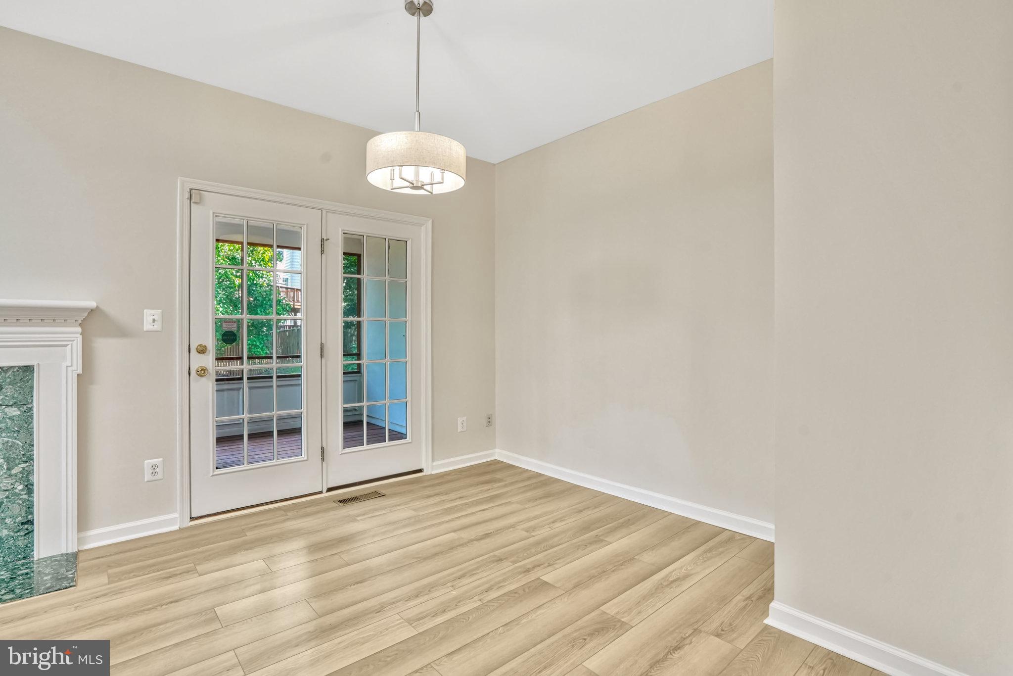 10159 Elgin Way Bristow, VA 20136 - Photo 24 of 50 a view of an empty room with wooden floor and a window