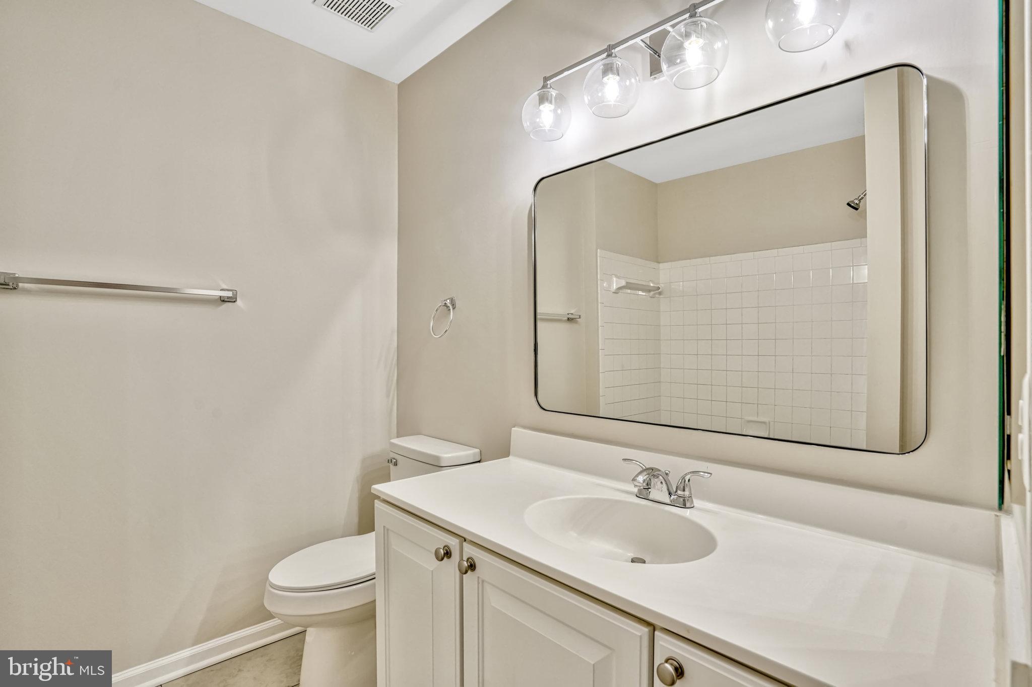 10159 Elgin Way Bristow, VA 20136 - Photo 31 of 50 a bathroom with a granite countertop sink and a mirror