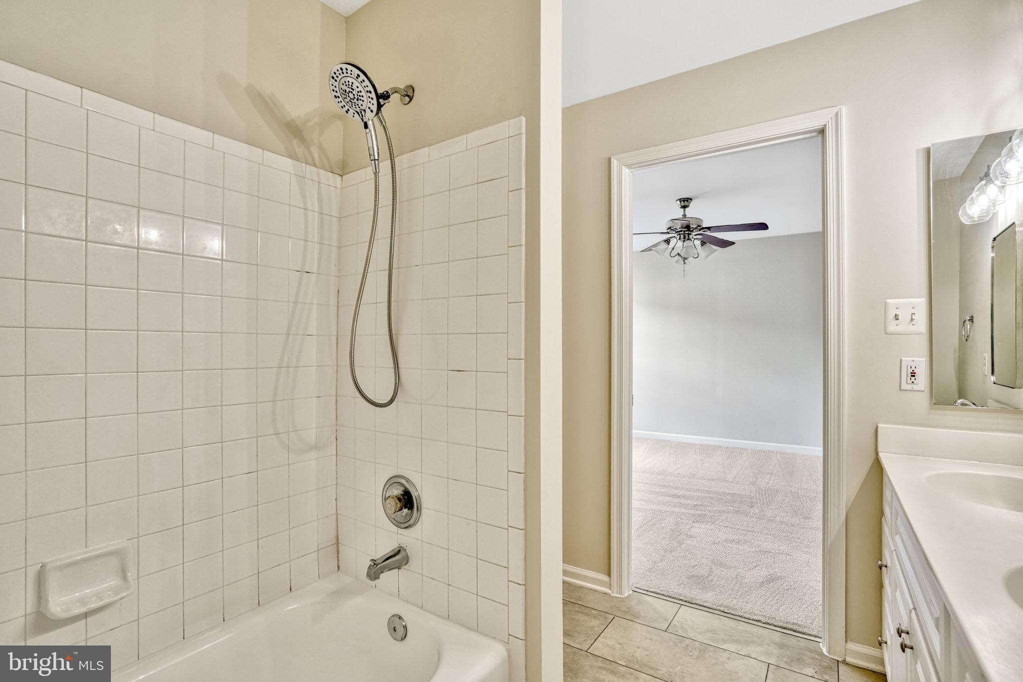 10159 Elgin Way Bristow, VA 20136 - Photo 37 of 50 a bathroom with a glass shower door