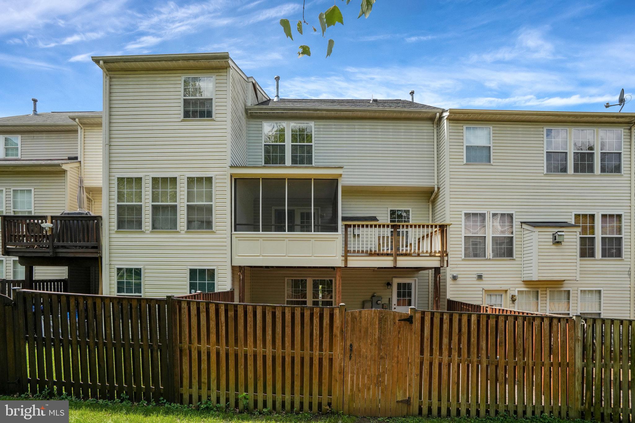 10159 Elgin Way Bristow, VA 20136 - Photo 48 of 50 a view of a large building with a wooden fence