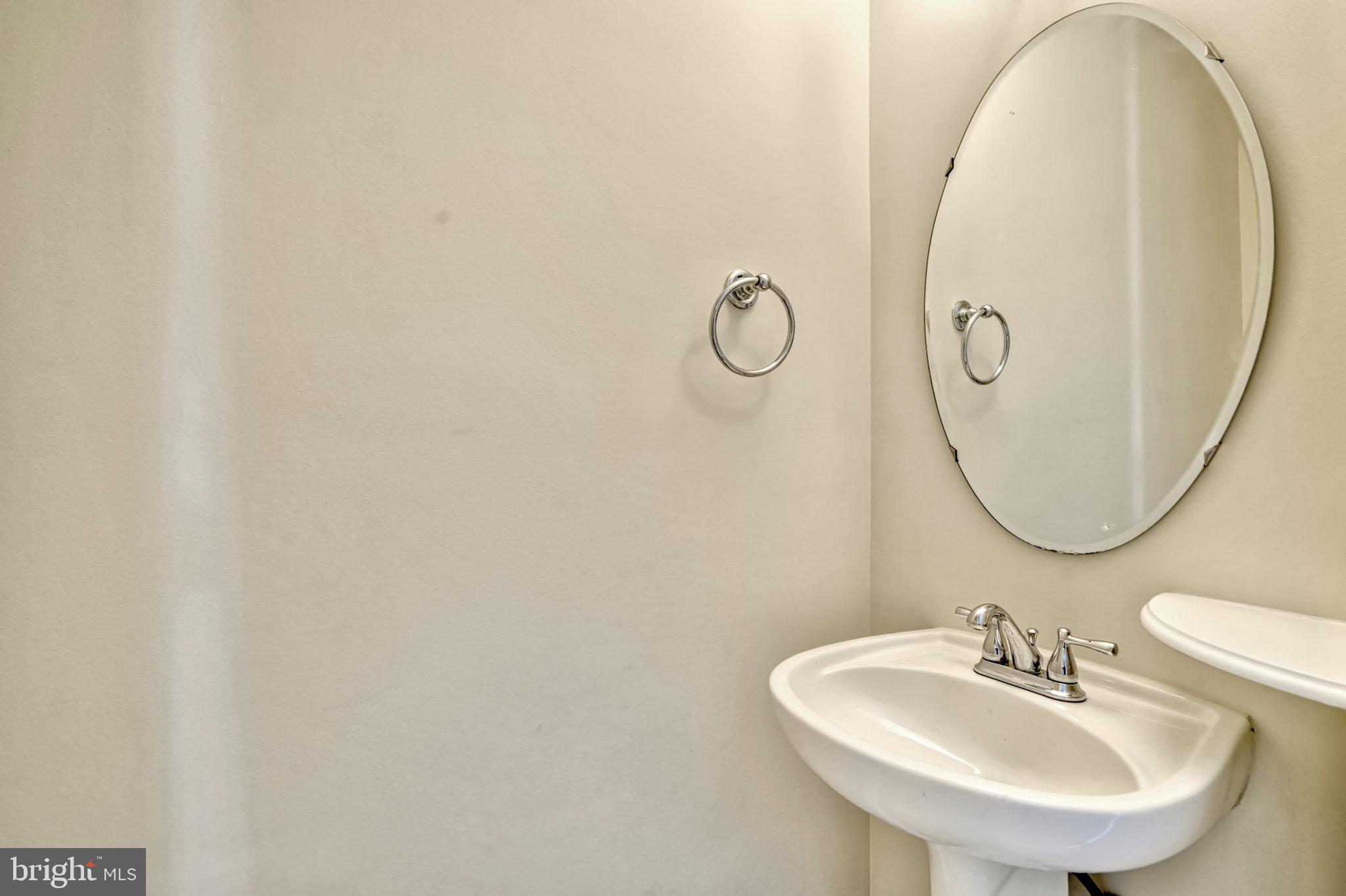 10159 Elgin Way Bristow, VA 20136 - Photo 6 of 50 a bathroom with a sink and mirror