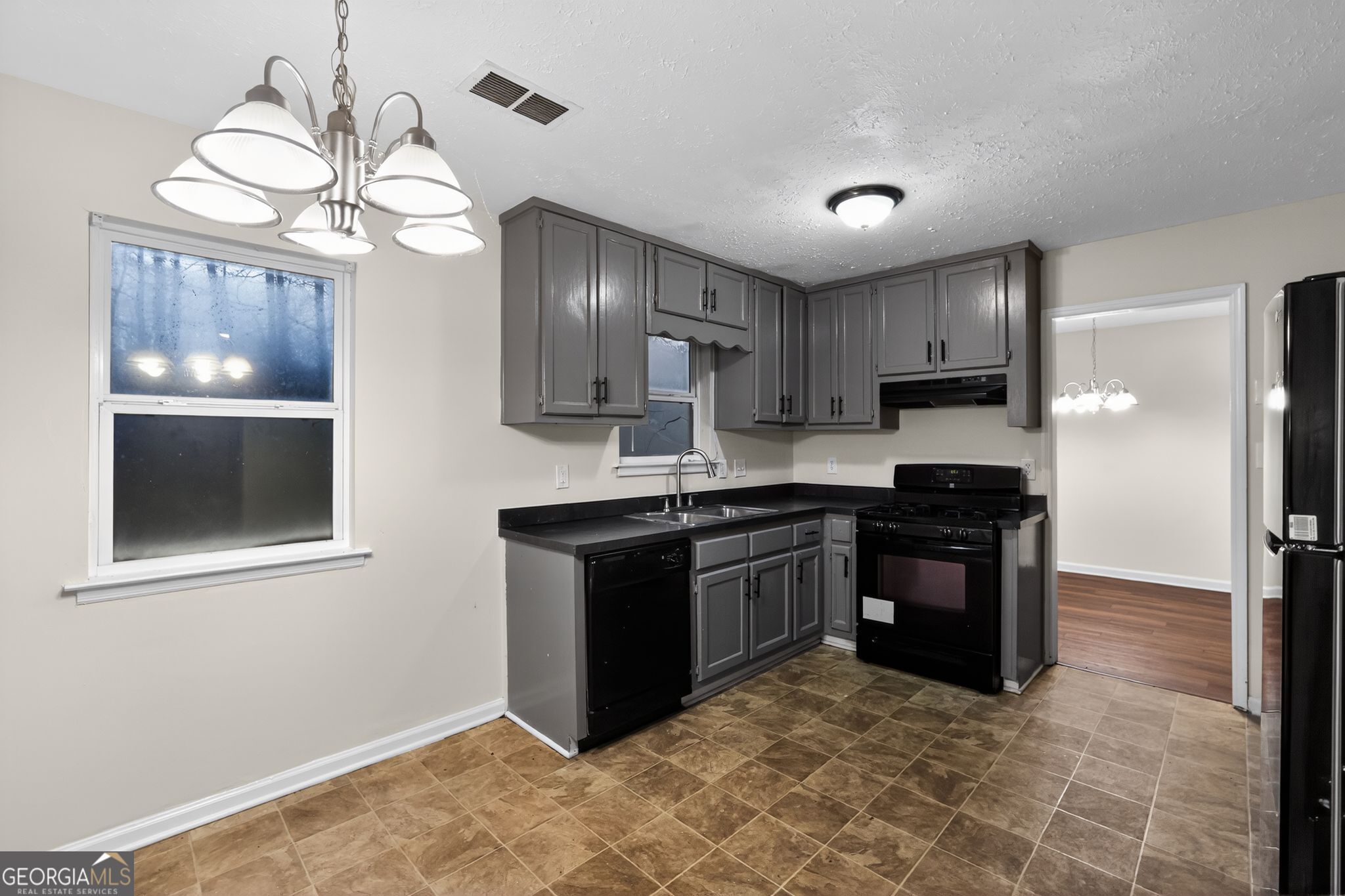 4586 High Gate Lane Lithonia, GA 30038 - Photo 11 of 33 a kitchen with stainless steel appliances granite countertop a stove and a refrigerator
