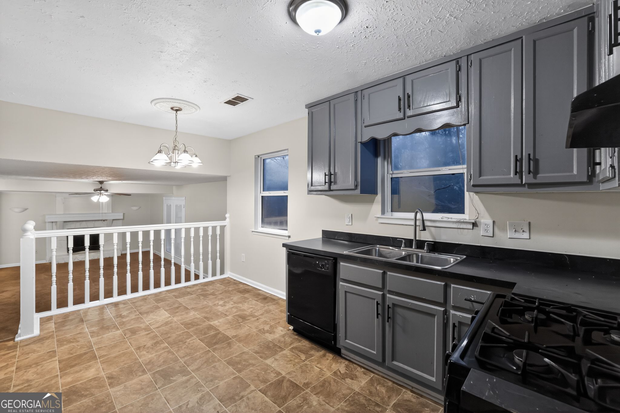 4586 High Gate Lane Lithonia, GA 30038 - Photo 12 of 33 a kitchen with stainless steel appliances a sink stove and cabinets