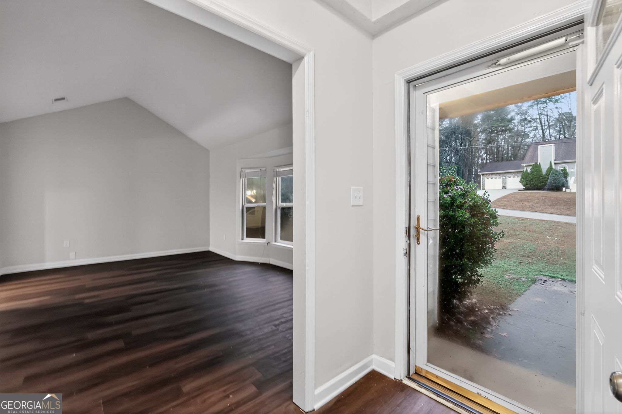 4586 High Gate Lane Lithonia, GA 30038 - Photo 6 of 33 a view of an empty room with wooden floor and a window