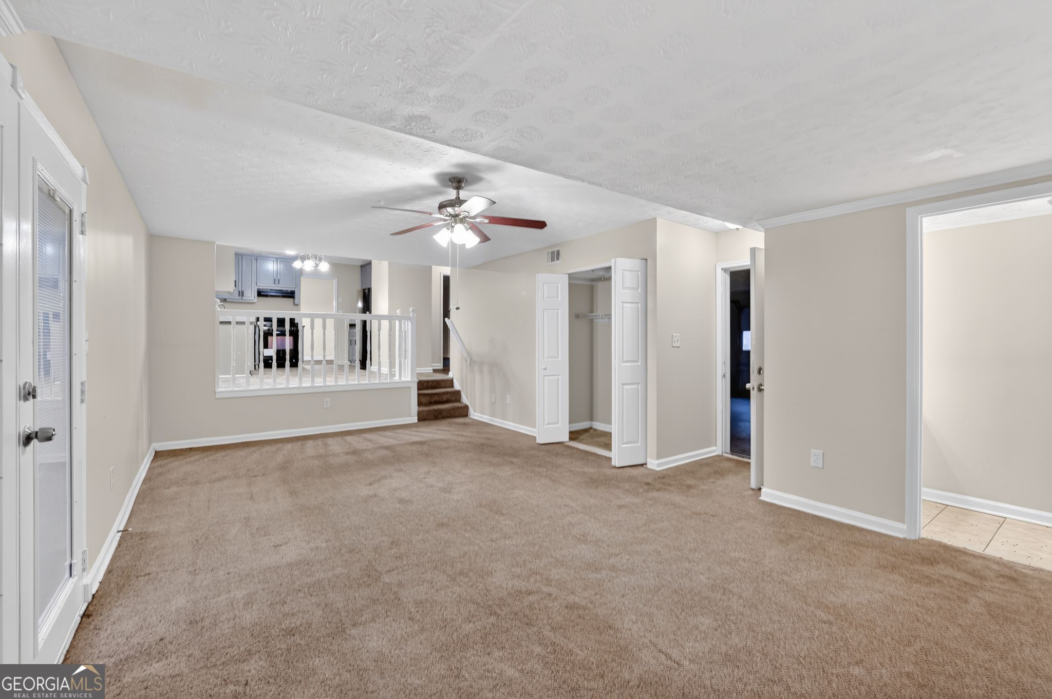 4586 High Gate Lane Lithonia, GA 30038 - Photo 7 of 33 a view of a big room with windows and chandelier fan