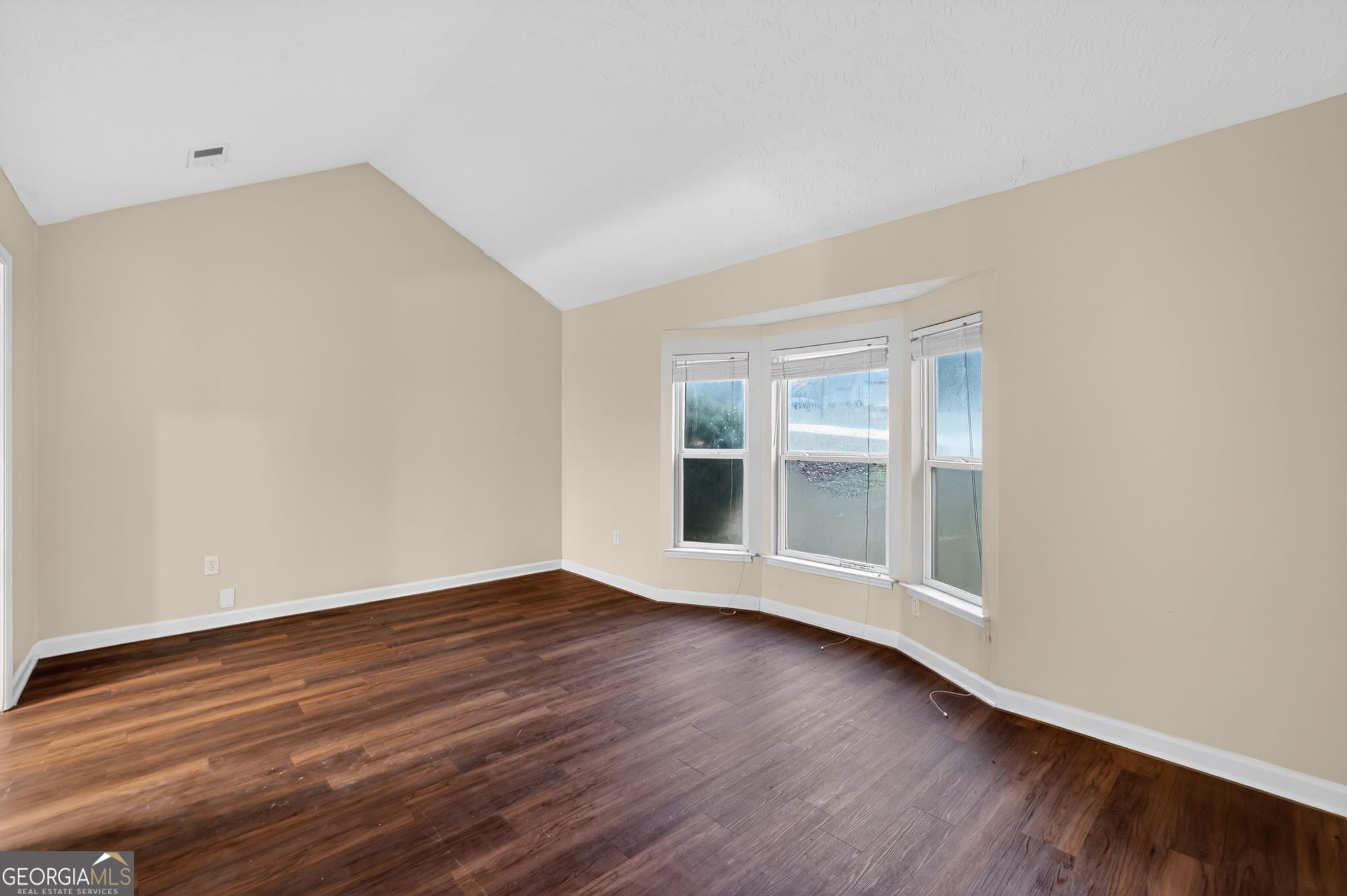 4586 High Gate Lane Lithonia, GA 30038 - Photo 10 of 33 a view of an empty room with wooden floor and windows