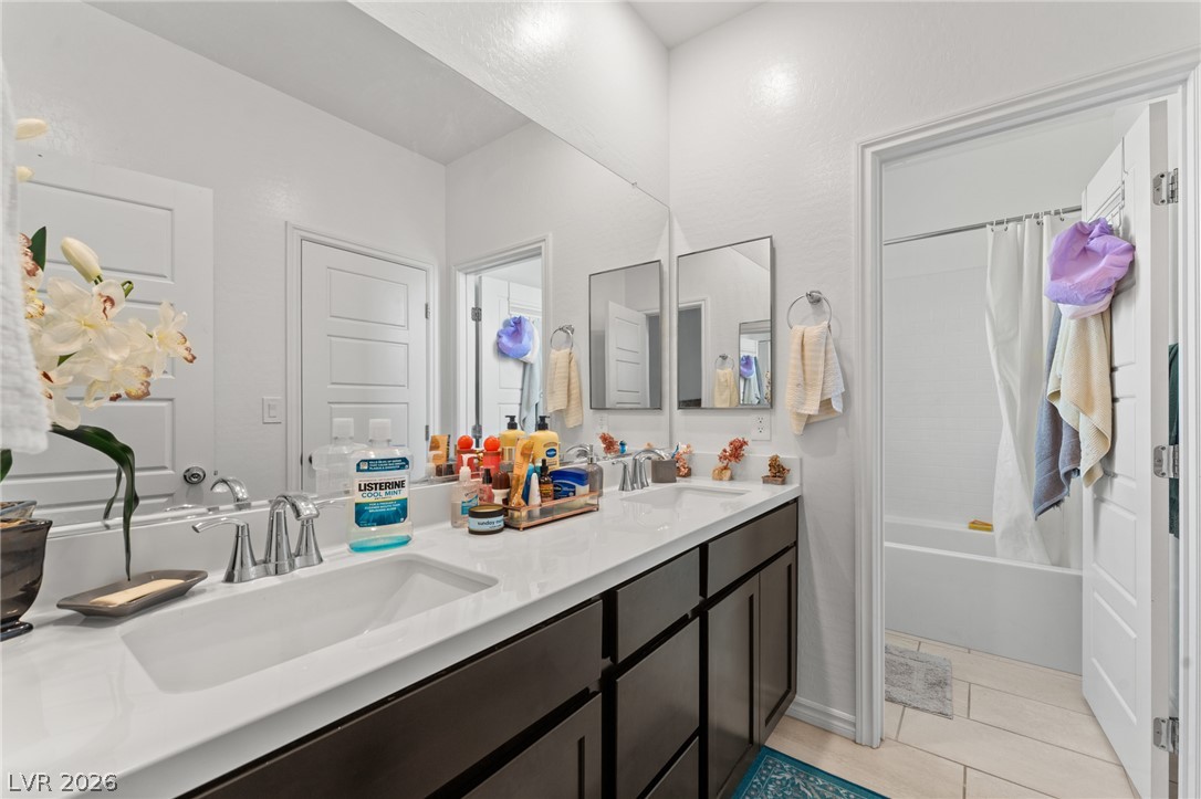 8879 Roadrunner Ravine Street Las Vegas, NV 89166 - Photo 29 of 39 Double vanity with ample counter space and sleek dark cabinetry awaits.