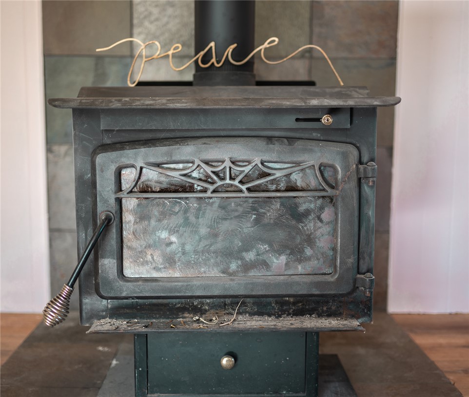 209 Cleveland Pike Road Westminster, SC 29693 - Photo 15 of 30 A classic wood-burning stove offers warmth and charm to any interior space.