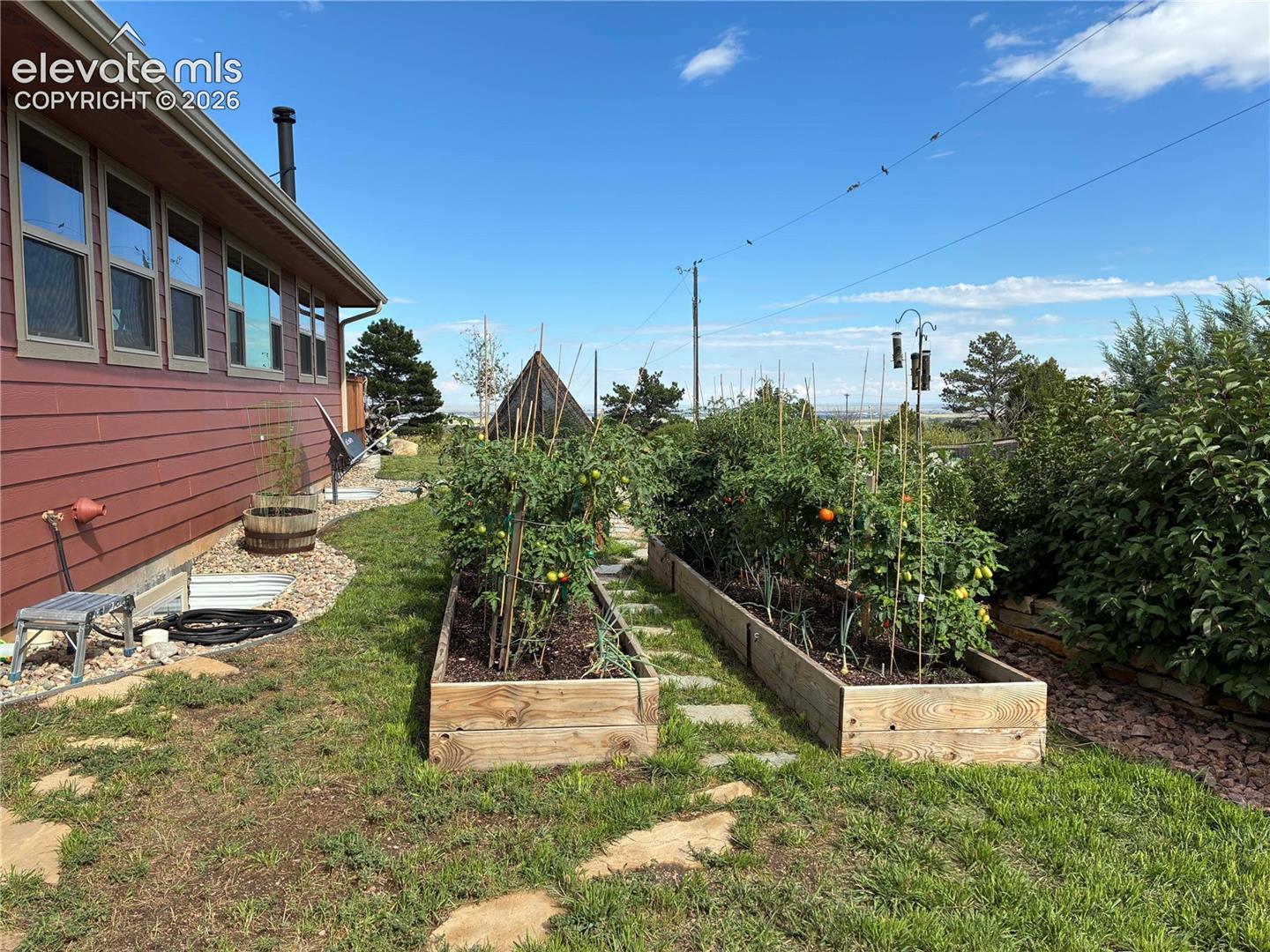 8480 Delaware Road Colorado Springs, CO 80926 - Photo 45 of 50 Summer 2025- View of the raised garden beds with vegetable garden