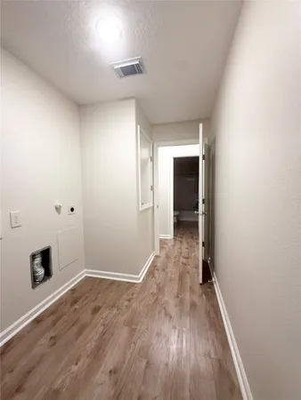 a view of hallway with wooden floor