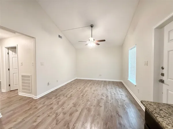 a view of a room with wooden floor
