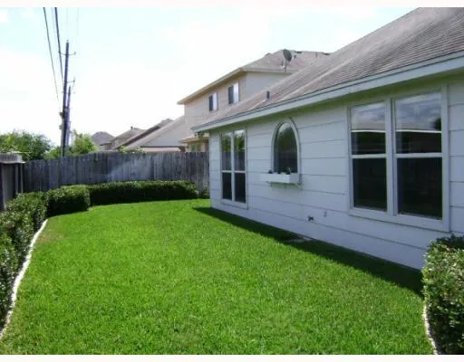 a view of house with backyard