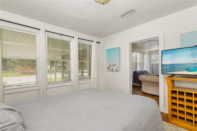 a bedroom with furniture and a window