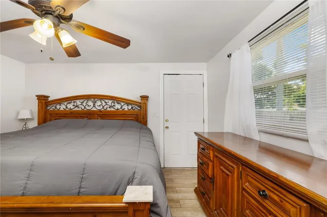 a view of a room with wooden floor and windows
