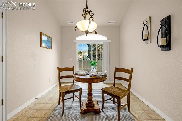 a dining room with furniture and window