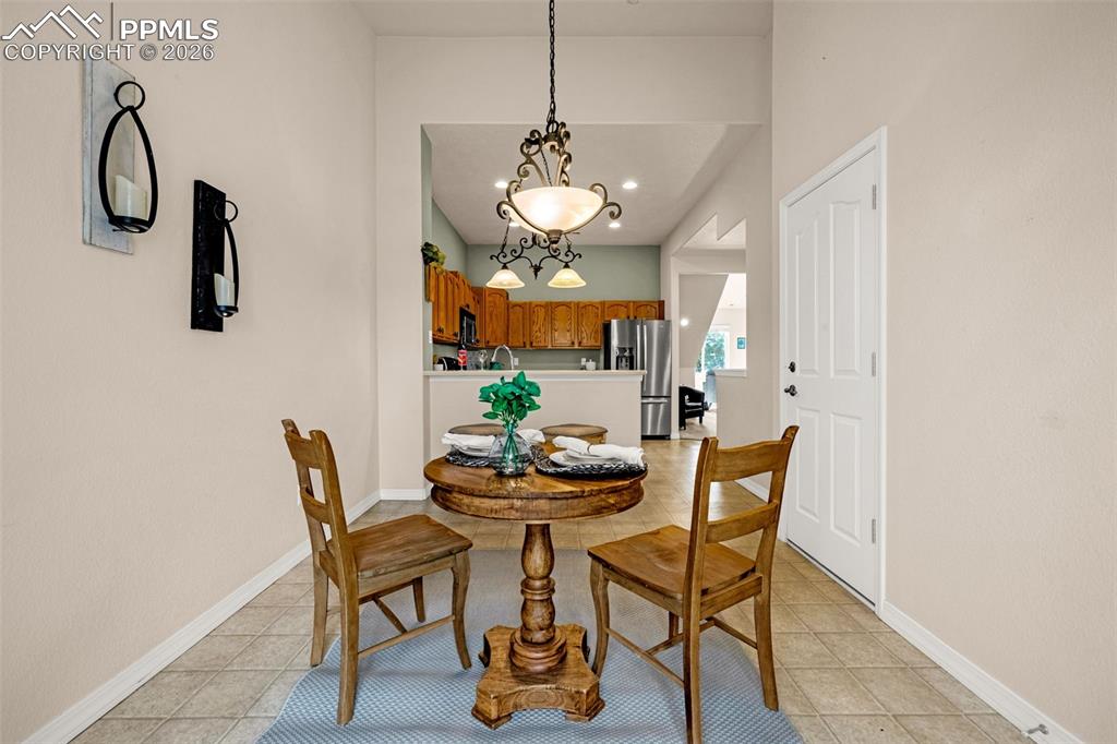 6658 Bethesda Point, Unit A Colorado Springs, CO 80918 - Photo 12 of 44 a dining room with furniture and window
