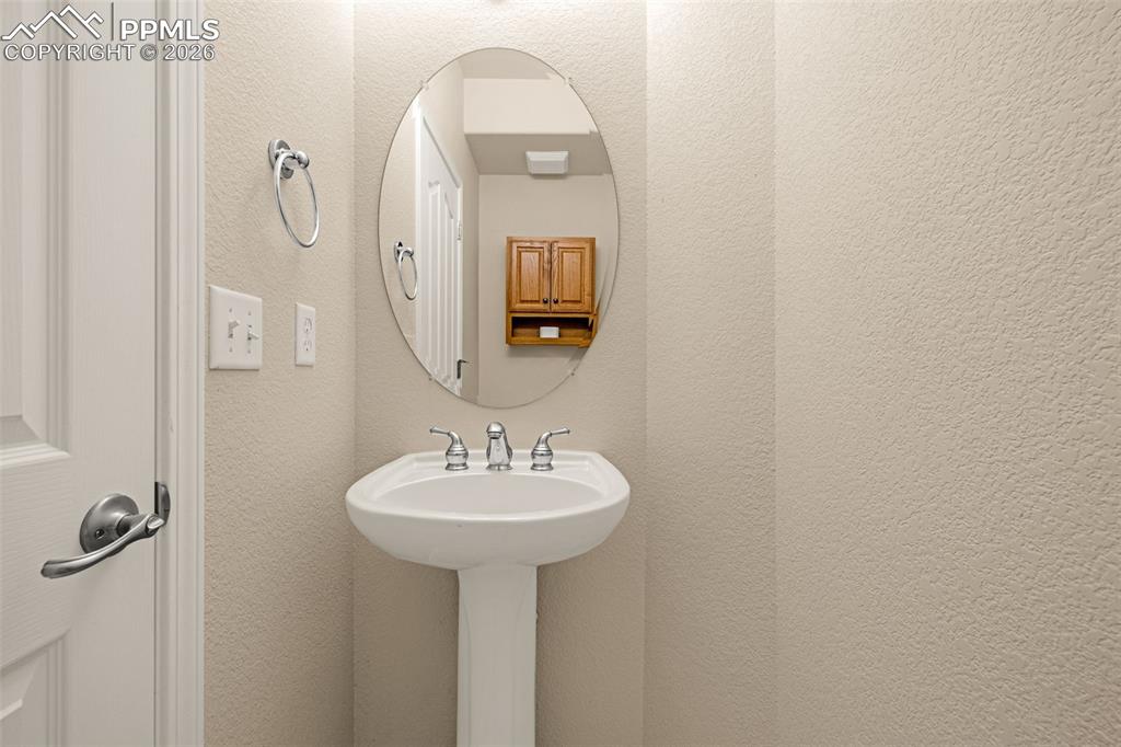 6658 Bethesda Point, Unit A Colorado Springs, CO 80918 - Photo 18 of 44 a bathroom with a sink and a mirror