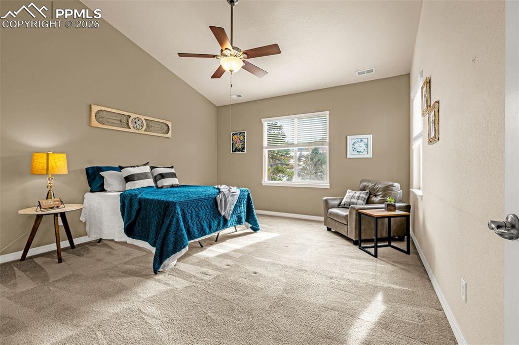 6658 Bethesda Point, Unit A Colorado Springs, CO 80918 - Photo 19 of 44 a bedroom with a bed and a chandelier