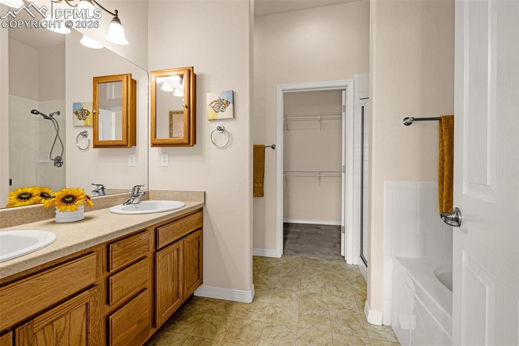 6658 Bethesda Point, Unit A Colorado Springs, CO 80918 - Photo 21 of 44 a bathroom with a sink vanity granite shower and a mirror