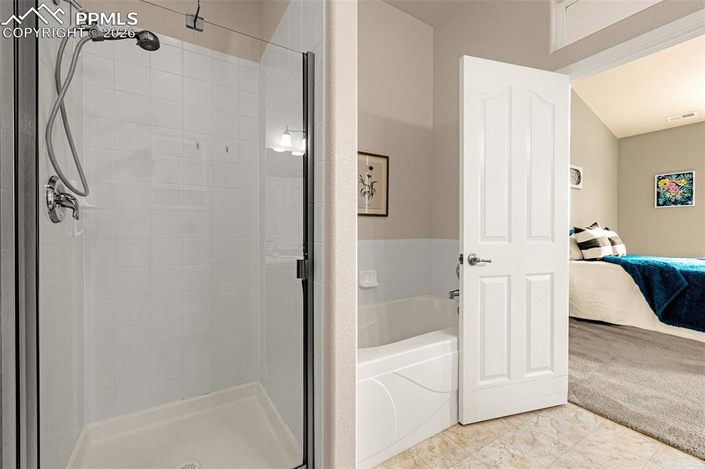 6658 Bethesda Point, Unit A Colorado Springs, CO 80918 - Photo 23 of 44 a bathroom with a bathtub and a shower