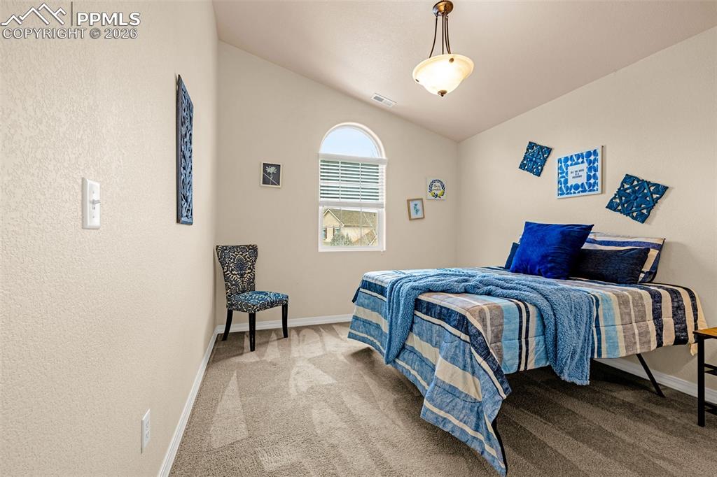 6658 Bethesda Point, Unit A Colorado Springs, CO 80918 - Photo 26 of 44 a bedroom with a bed and a chair