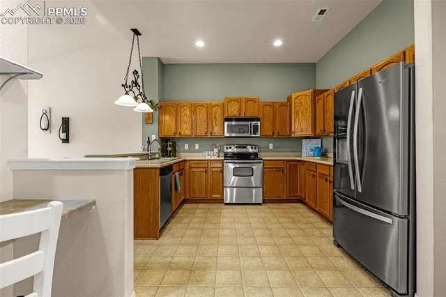 a kitchen with a refrigerator a sink and a stove
