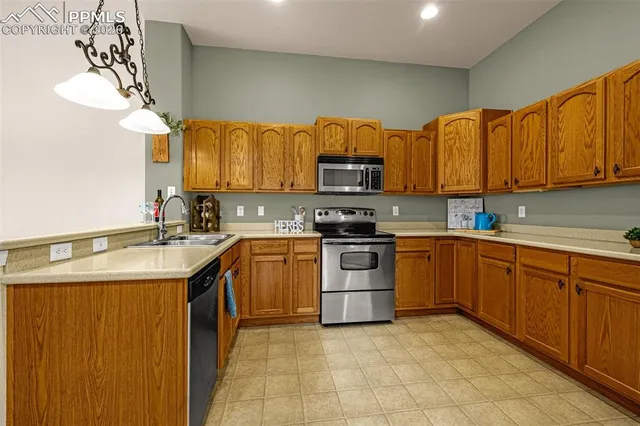a kitchen with stainless steel appliances granite countertop a sink and cabinets